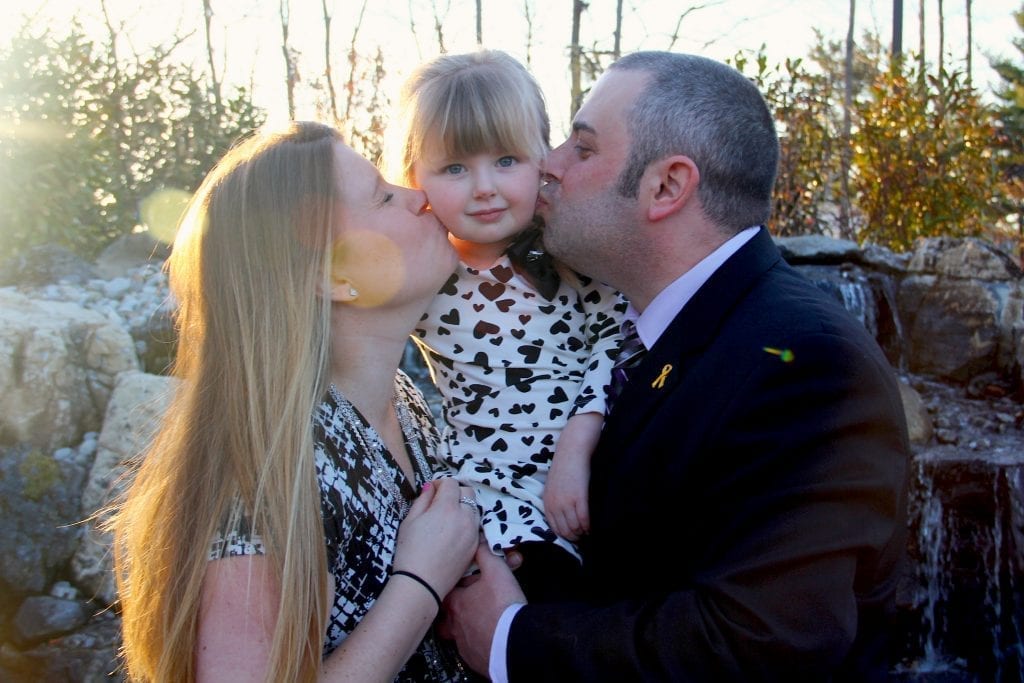 Cancer-hero Emma with her parents AJ and Lindsey Wyman