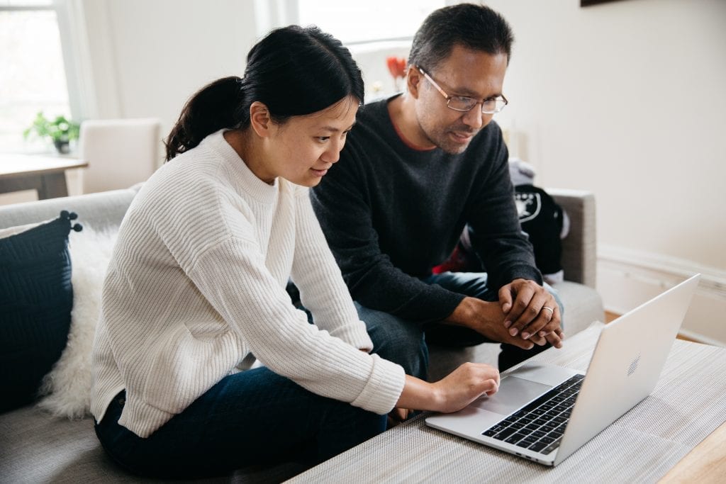 Couple looking at Financial Planning for Cancer Program on laptop