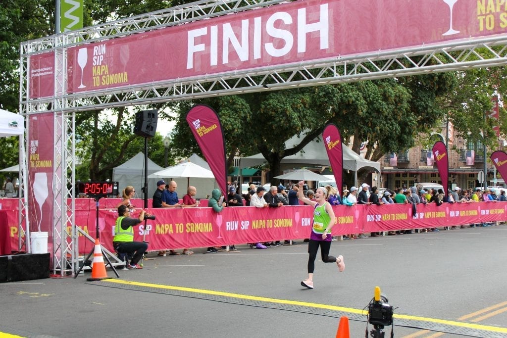 Kasey running through the finish line