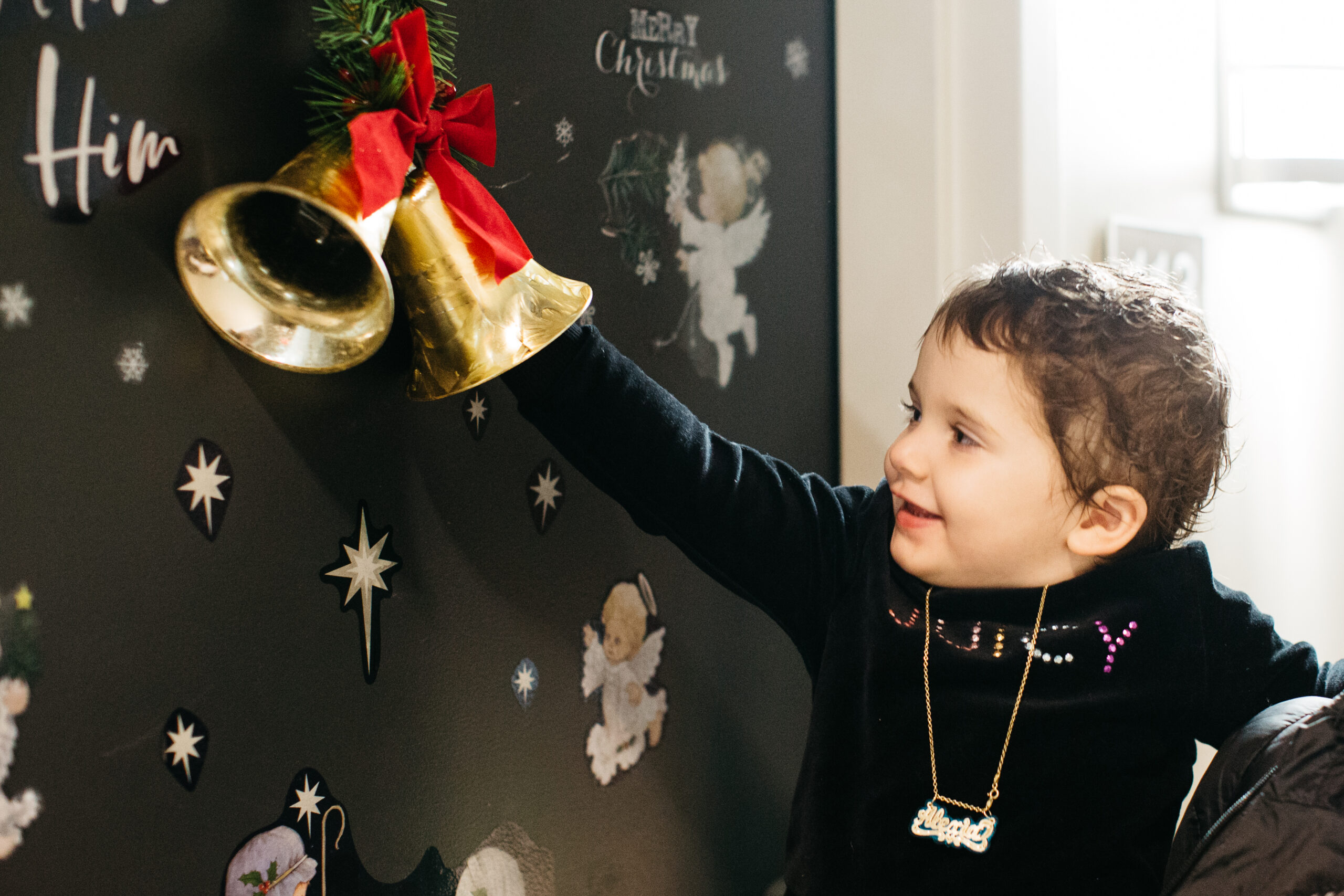 Pediatric cancer patient ringing holiday bell