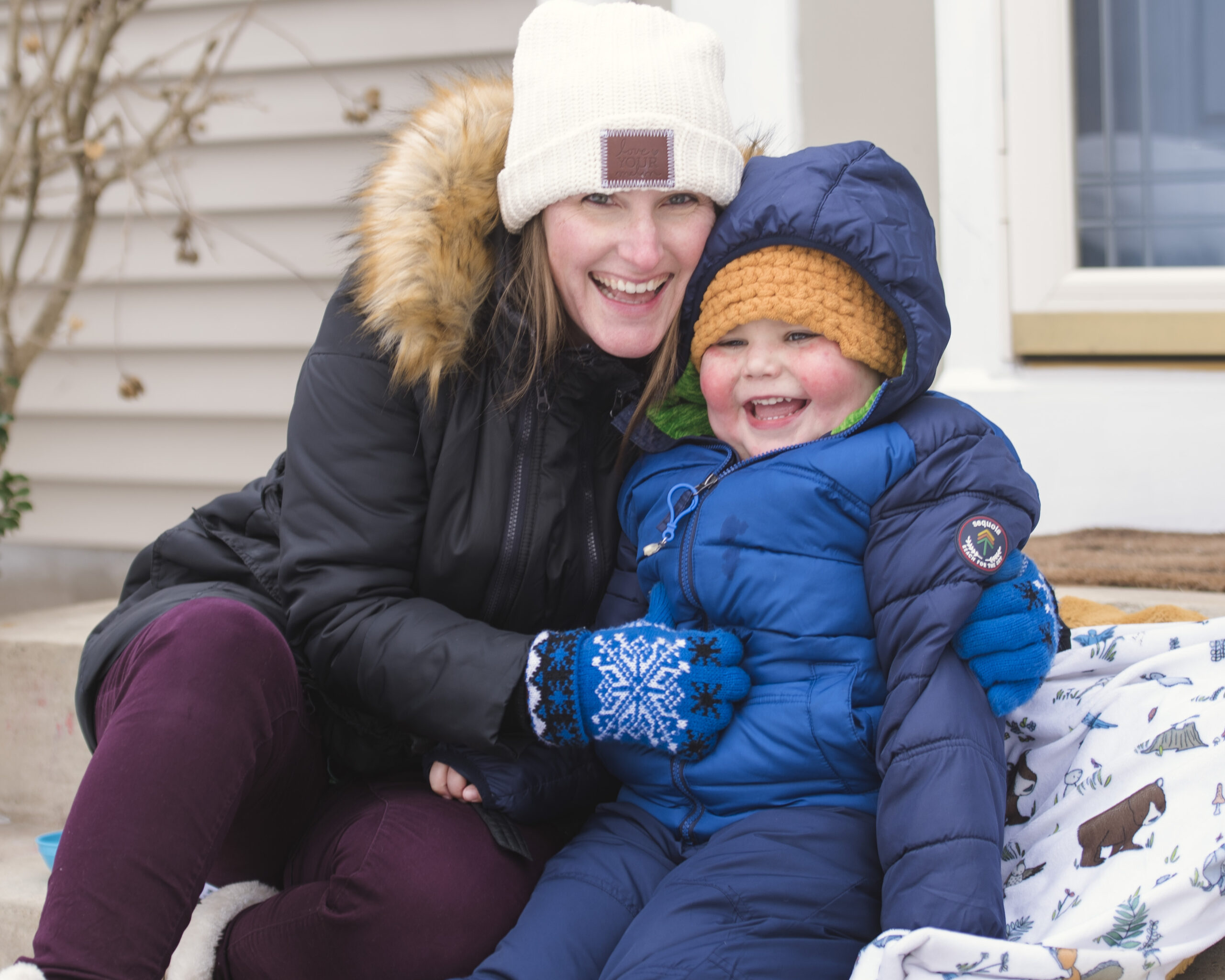 cancer hero Ollie with his Mom outdoors in winter coats and hats