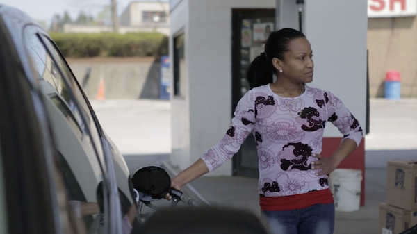 Woman pumping gas