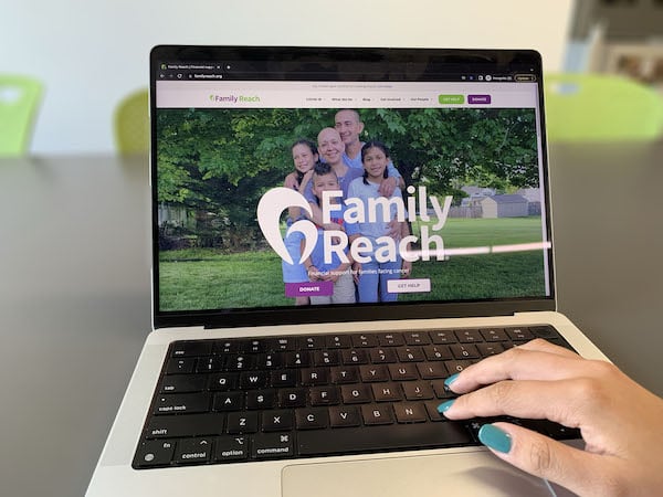 Someone using laptop that's open to Family Reach website
