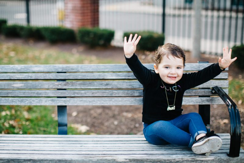 Cancer hero Alexia raising her arms triumphantly