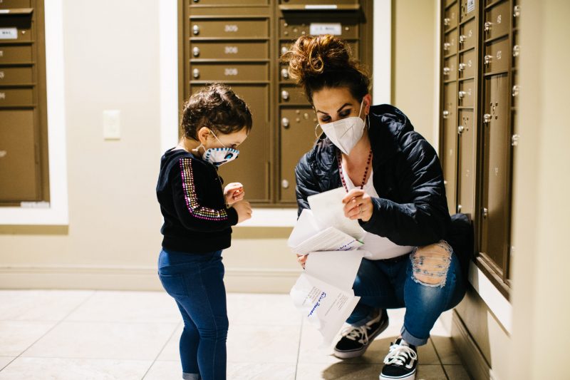 Mom of cancer patient looking at bills and other mail