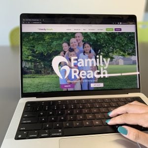 Someone using a laptop that's open to Family Reach website