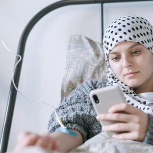 Cancer patient looking at phone